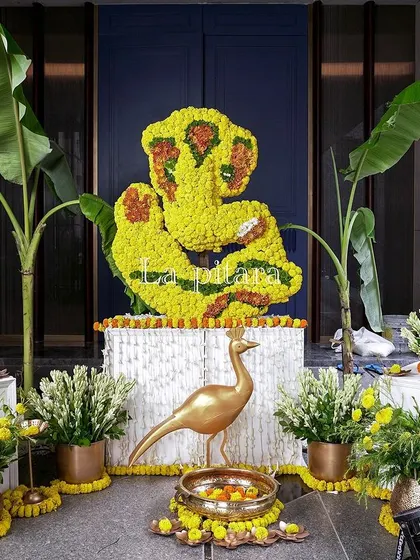 Another beautiful floral Ganesha installation, framed by banana plants for a traditional touch. This setup, complete with a golden peacock figure, served as a divine focal point for the celebration.