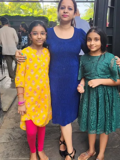 A proud teacher with her students at our Mela Music School concert. These events are a celebration of our students' success and a chance for our community to connect.