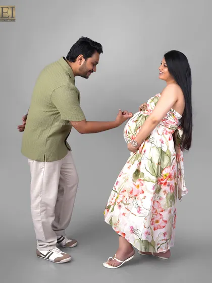 A playful interaction between the couple during their studio session, adding a lighthearted and fun element to their maternity album.