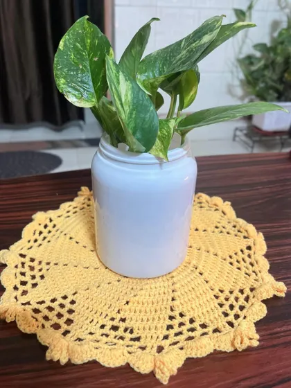This simple, sunny yellow crochet doily is the perfect size to place under a small plant pot, adding a bit of color to your space.