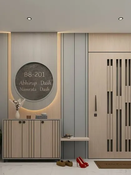 A modern entryway featuring a custom nameplate, a sleek cabinet, and a small shoe bench. The curved, backlit panel adds a soft, welcoming glow.