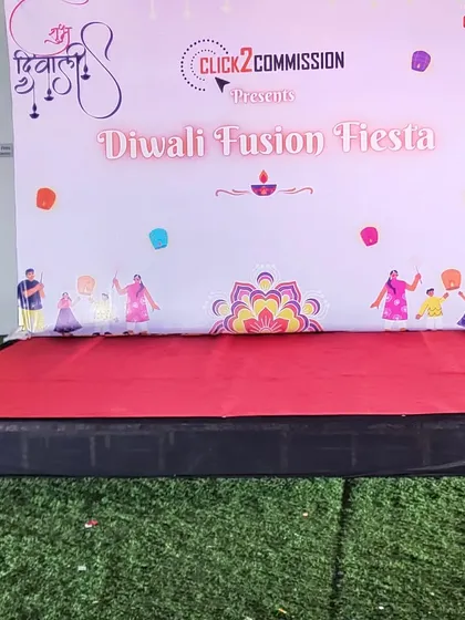 A custom-branded photo backdrop and stage for the "Diwali Fusion Fiesta". This creates a perfect spot for team photos and performances.