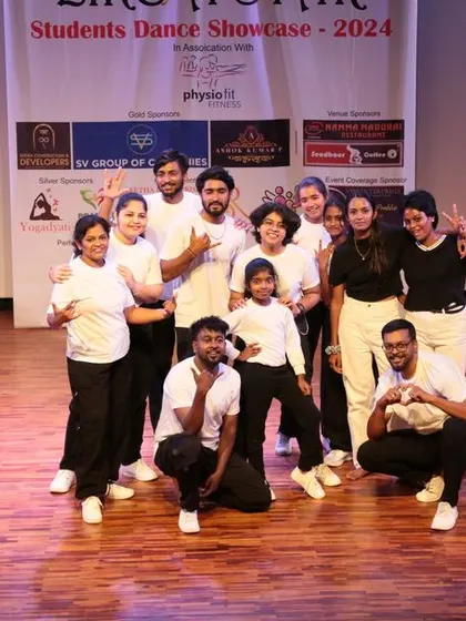 A proud moment for our students and instructors on stage. This group photo captures the joy and camaraderie of our dance community after a great performance.