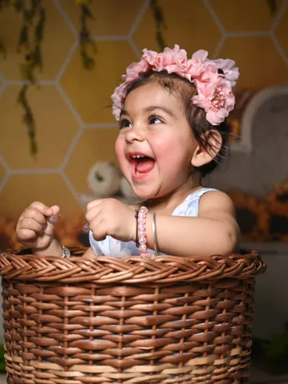 A basket of joy! Placing babies in props like this wicker basket adds a charming and classic touch to their portraits, especially with her huge, happy laugh.