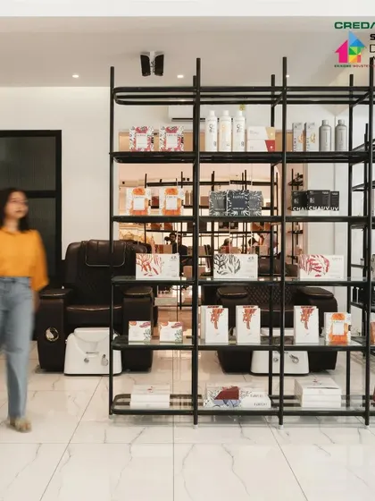We used open, metal-frame shelving as a semi-transparent divider between spaces. It defines the area without closing it off, and doubles as an elegant retail display.