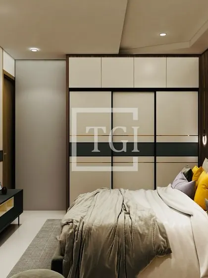 A view of a bedroom concept, highlighting the sleek sliding wardrobe and a built-in TV unit, demonstrating our focus on space-saving and functional design.