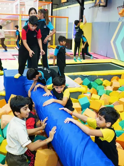 Students battling it out on the balance beam over the foam pit. It's a fun and safe way to challenge their agility and have a great time.