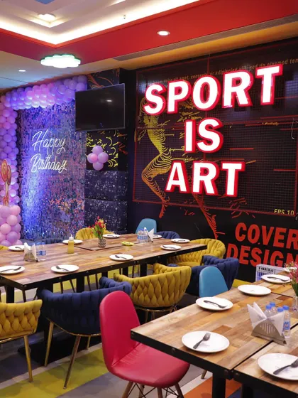 A wider view of the party dining space, showing how I can arrange the seating for large groups while maintaining a festive vibe with balloon decorations.