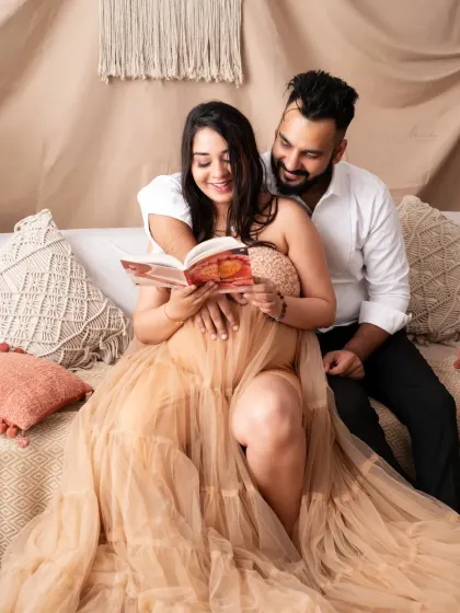 We love capturing these candid, happy moments. The shared laughter while looking at a book makes this couple's portrait feel so genuine and full of love.