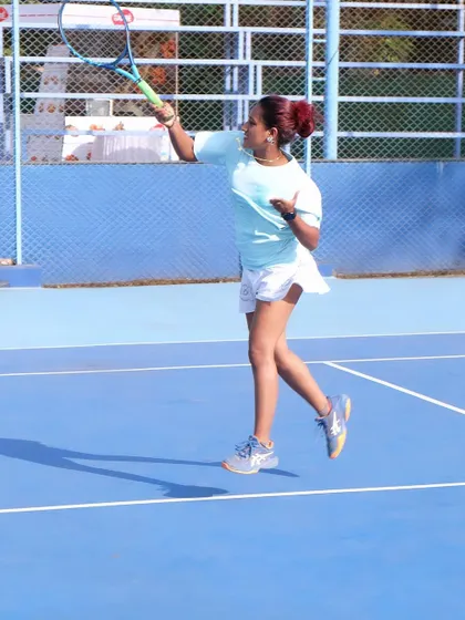 A high-energy shot from a match, showcasing proper form and follow-through. I use my own playing experience to provide practical, real-world feedback to my students.