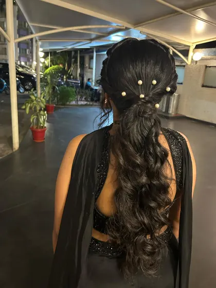 A messy, textured ponytail is a great option for a sangeet or reception. It's stylish, modern, and keeps your hair off your face while you dance.