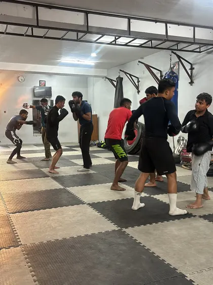 A group of students practicing their shadow boxing form in unison. This builds discipline and reinforces correct technique.