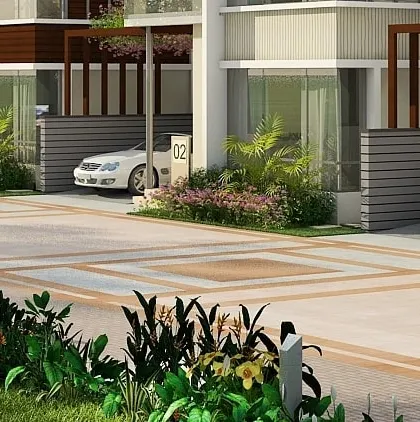 A close-up of the entrance and carport for one of the row houses, demonstrating the attention to detail in the paving and landscape design.