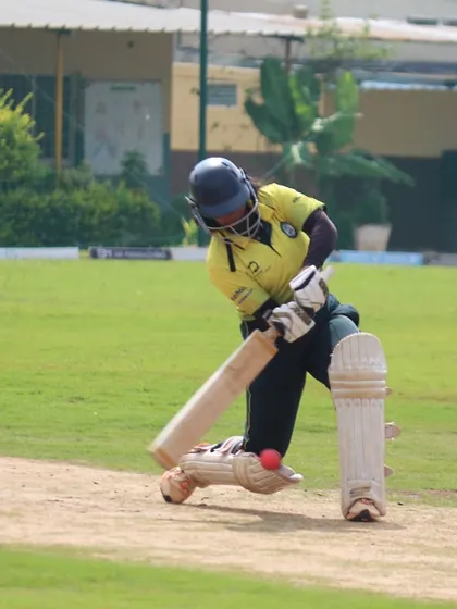 A dynamic shot of a batter connecting with the ball on the front foot.