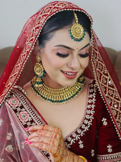 A smiling bride, her eyes closed, showing the perfectly blended eyeshadow.