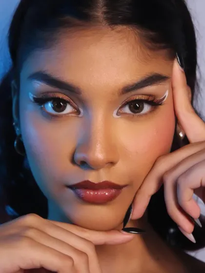 This shot showcases the full effect of the graphic liner, creating a sharp, futuristic look.