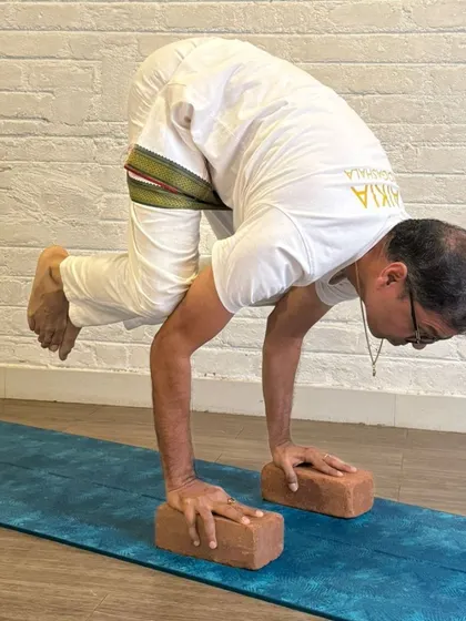 Dedication shines through as this TTC student practices Bakasana. The pose strengthens not only the arms and core but also the mental resilience required to hold steady under pressure.