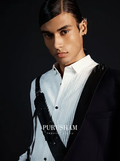Accessories are the exclamation point that elevates a look. This image showcases one of my custom leather harnesses, a signature detail that adds a modern, powerful edge to a classic shirt.