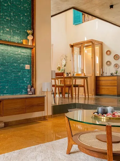 A similar view of the living and dining space in 'The Valley', highlighting the double-height volume and the flow of light through the home.
