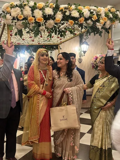 A close-up of the happy Kashmiri bride during her entry. The floral chaadar, crafted with fresh roses and chrysanthemums, perfectly frames her joyful expression.