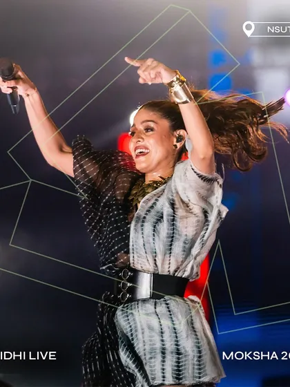 A high-energy shot of Sunidhi Chauhan commanding the stage at Moksha 2024.