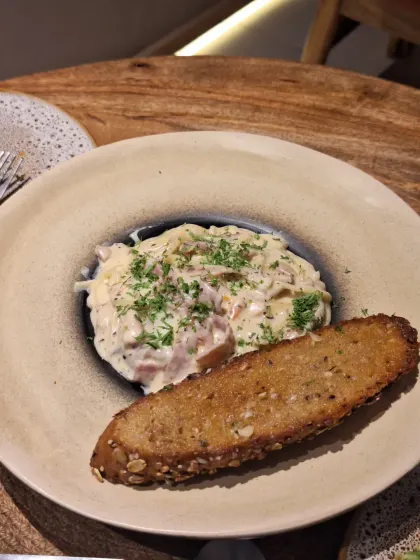 Creamy pasta with garlic bread at La Croute. A classic comfort dish executed perfectly.