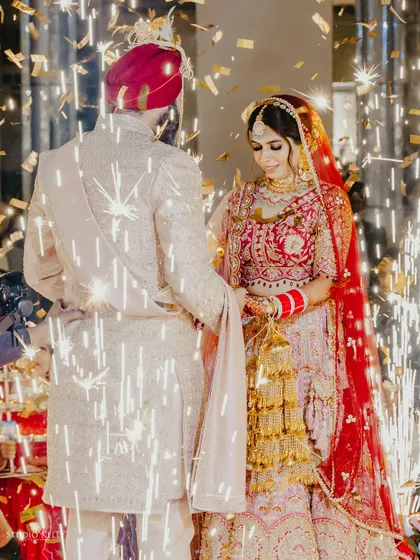 A magical Varmala moment, with the couple surrounded by sparklers and confetti.
