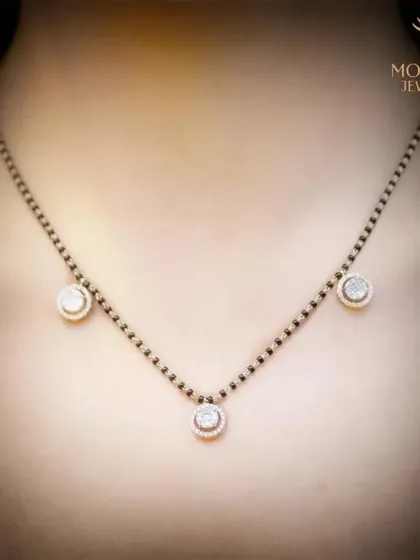 A modern interpretation of the traditional Mangalsutra, this delicate necklace features three diamond halos on a classic black-beaded chain. It is a symbol of love and commitment, designed for the contemporary woman.