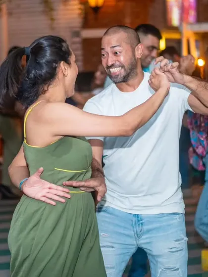 A moment of pure, explosive laughter during a dance. It’s impossible not to have a good time here.