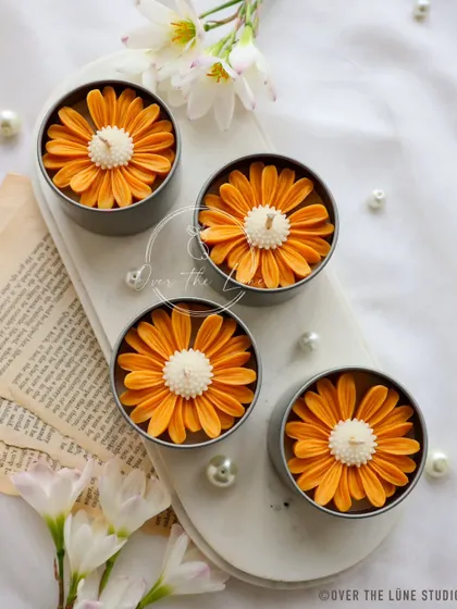 A set of four of my orange Daisy Mini Candles. The color is so vibrant and happy, perfect for brightening up any space.