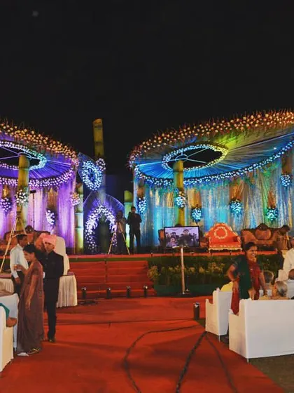 This unique outdoor stage design features two large, circular structures with colourful draping and lighting. It's a creative option for a large sangeet or reception event.