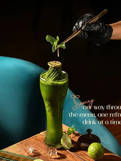 This is our refreshing mint and lime creation, a perfect example of how we use fresh, vibrant ingredients. Each drink is crafted to be a visual delight, garnished with care before it reaches your table.