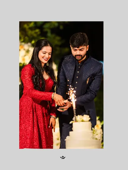 The couple cuts their wedding cake, a sweet moment from their reception surrounded by sparklers.