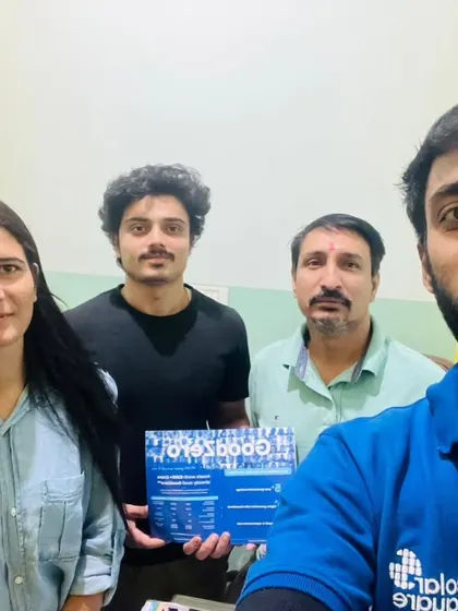 Our team with a family holding our "GoodZero" brochure.