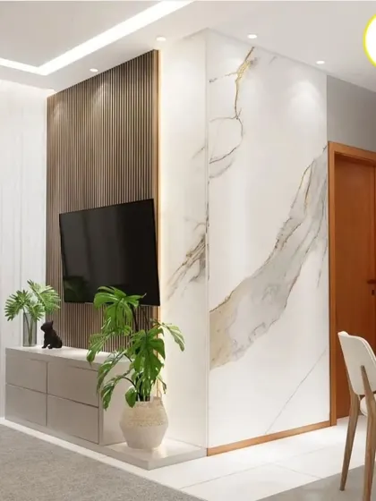 This image shows how a marble-finish accent wall can wrap around a corner, creating a seamless and high-end look for the TV area.