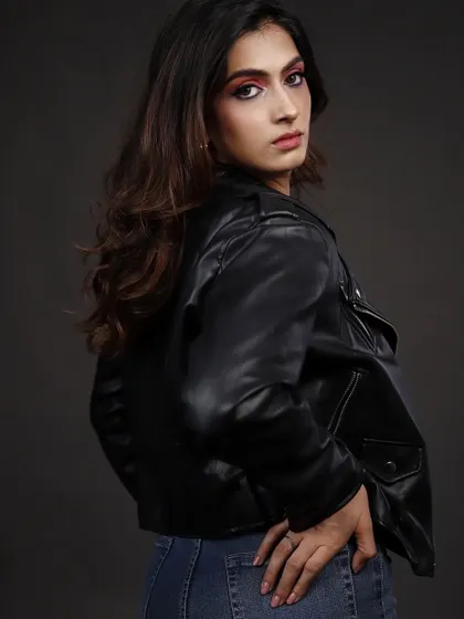 A profile shot in the same leather jacket look, adding another dimension to the portfolio. It shows a different angle and highlights the model's features from the side.