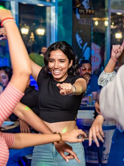 The center of the action. A guest dancing and pointing, drawing everyone into the fun. The energy is contagious.