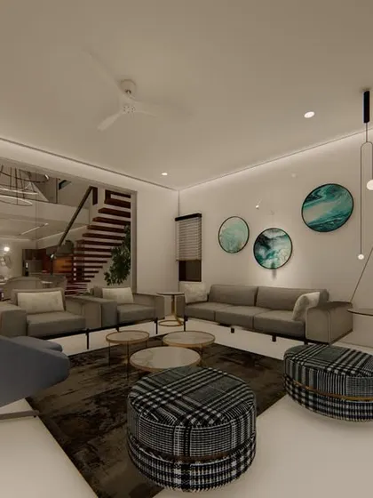 This living room uses a cool, contemporary color palette of greys and blues. The open-plan space flows into the dining area and staircase, creating a sense of spaciousness, while curated art adds a personal touch.