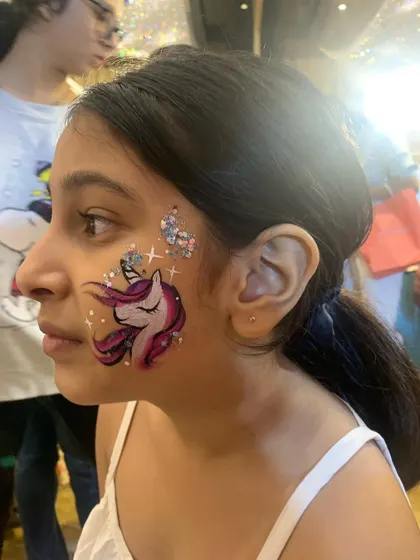 A slightly different angle of our classic unicorn face paint, showing how the design sparkles in the light.