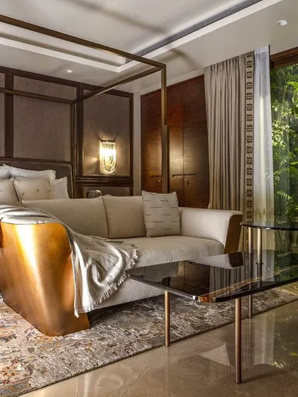 This bedroom in the Barkat residence opens onto a private balcony, seamlessly extending the tranquil interior into the outdoors. The design ensures that the connection to nature is a constant presence, even in the most private spaces of the home.
