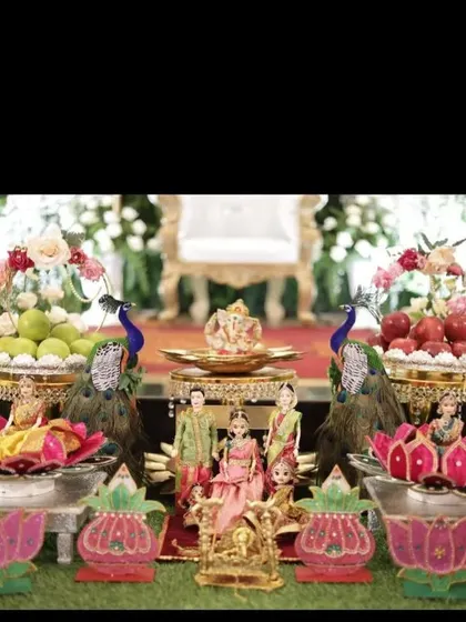A grand seemantham setup with peacock figures, multiple dolls, and a central Ganesha idol, creating a rich and traditional look.