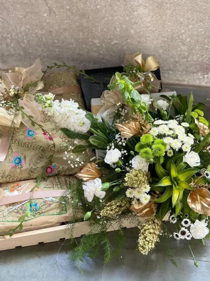 Introducing the art of thoughtful gifting. This bespoke hamper features our finely embroidered shawls, elegantly packaged and paired with fresh florals and decorative elements in a keepsake wooden tray. It represents a perfect gesture for weddings, festive celebrations, or any milestone moment.