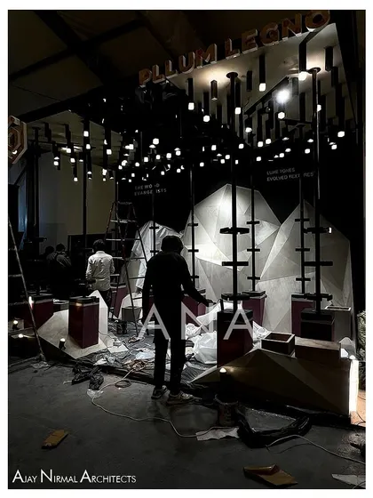 The Pllum Legno installation during the final stages of setup. The lighting grid is in place and protective coverings are still on the floor as our team makes the final adjustments before the show opens.