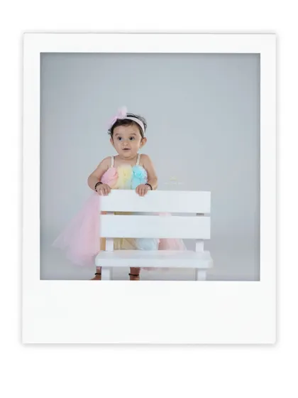 A beautiful portrait in a polaroid-style frame. This little girl looks so sweet and elegant in her pastel dress.