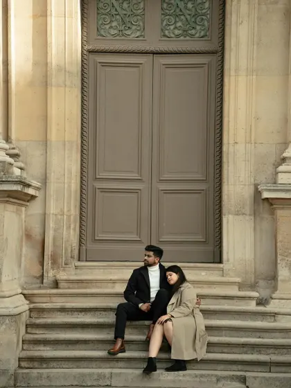 A quiet moment of rest on the steps of a grand Parisian building. These unposed shots often become the most cherished memories.