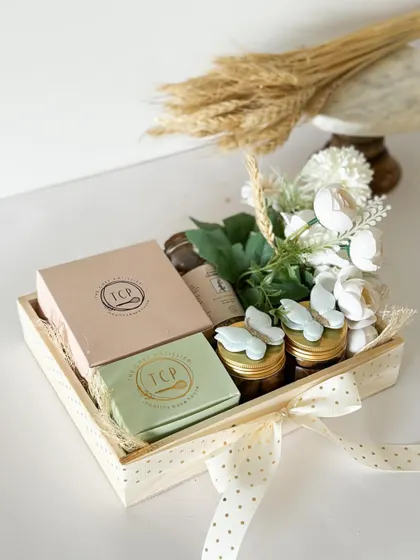 A beautiful wooden tray hamper curated for a baby announcement. The butterfly accents and polka-dot ribbon add a touch of sweetness to the celebration.