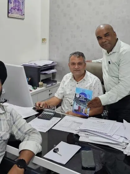 Our team with a customer, holding our solar guide.