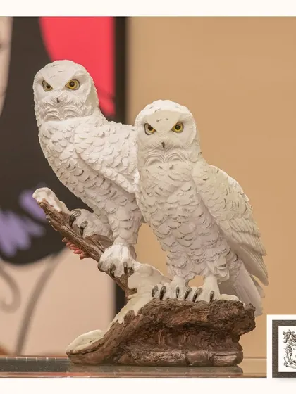 This mystical statue of two snowy owls perched on a branch is a symbol of wisdom and mystery. The intricate feather detailing makes it a beautiful and captivating piece for any nature lover.
