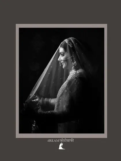 A classic black and white shot of bride Nikita under her veil, her smile radiating pure happiness.