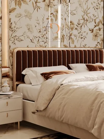 A close-up of the channel-tufted velvet headboard, framed by mirrored panels and elegant wall sconces that enhance the room's opulent feel.